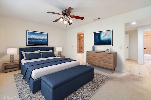 tiled bedroom with ceiling fan and connected bathroom