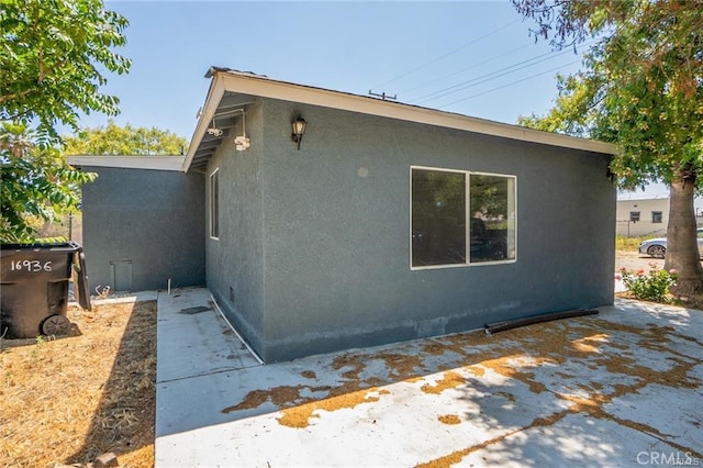 view of side of home with a patio area