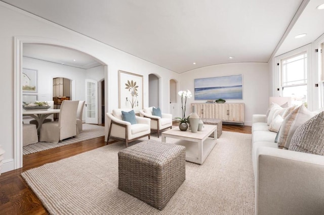 living room featuring radiator heating unit, vaulted ceiling, and hardwood / wood-style floors