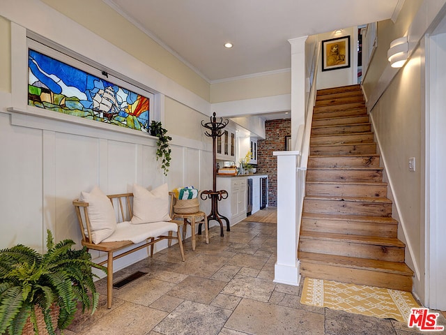 stairway with crown molding and beverage cooler