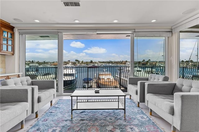 sunroom / solarium featuring a water view