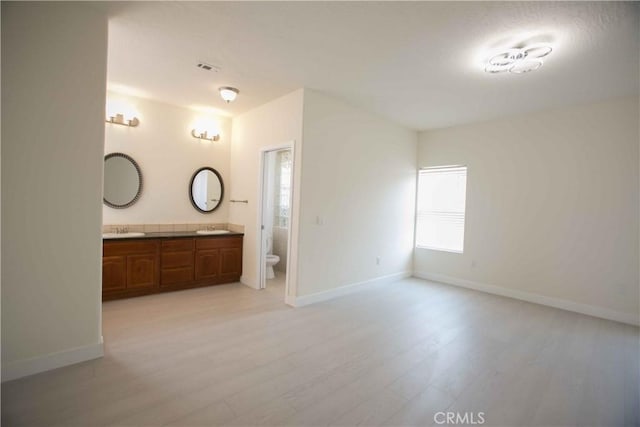 bathroom with toilet, vanity, and hardwood / wood-style flooring