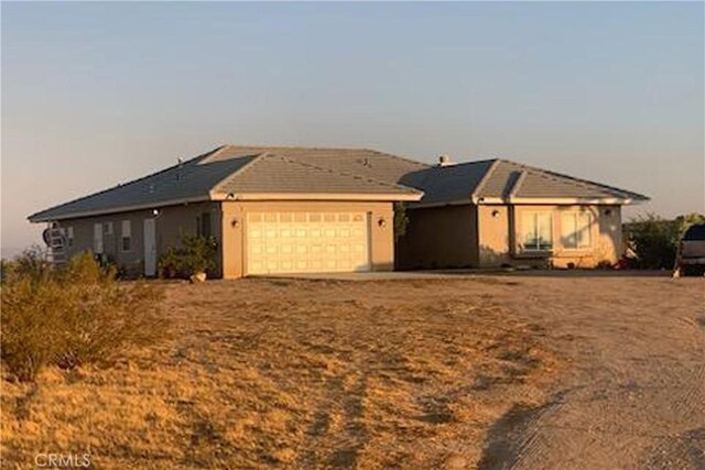 ranch-style house featuring a garage