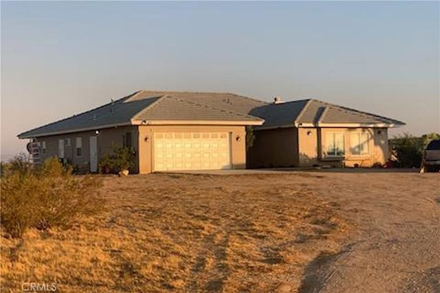 ranch-style home featuring a garage