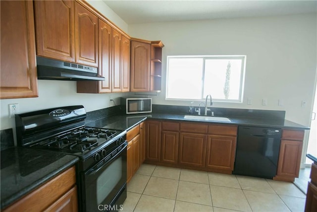 kitchen featuring black appliances, sink, and light tile patterned flooring