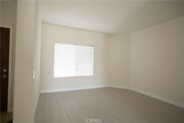 unfurnished room with light hardwood / wood-style flooring