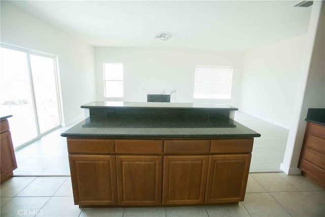 kitchen with light tile patterned floors and a center island