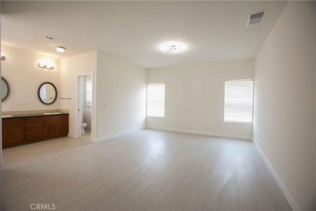 interior space featuring light hardwood / wood-style floors and connected bathroom