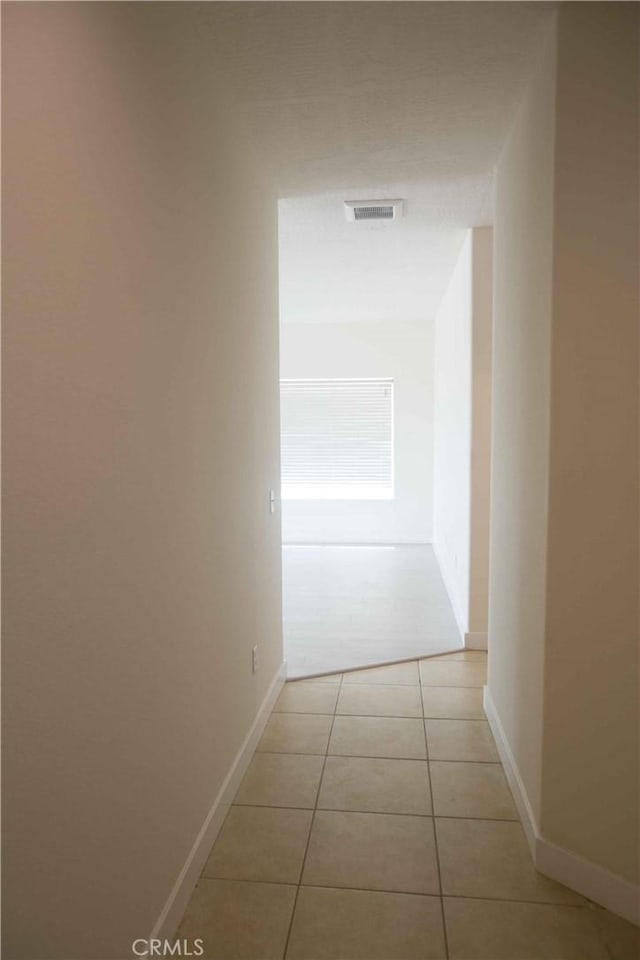 hallway with light tile patterned floors