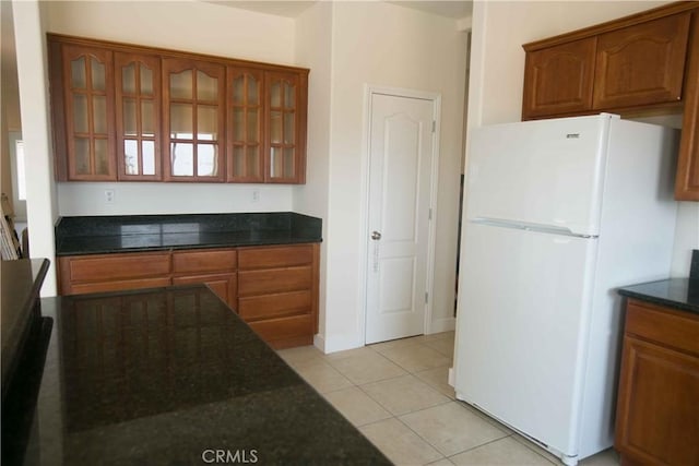 kitchen featuring light tile patterned flooring and white fridge