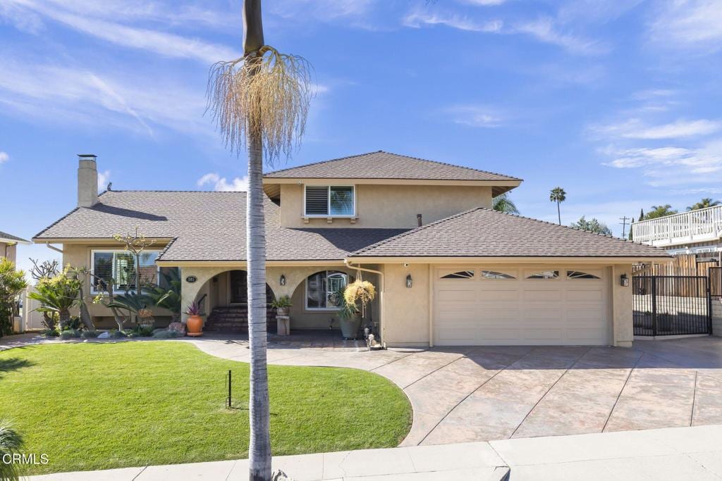 view of front facade with a garage and a front yard