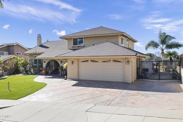 view of property with a garage and a front yard