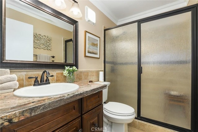 bathroom with toilet, a shower with shower door, decorative backsplash, ornamental molding, and vanity