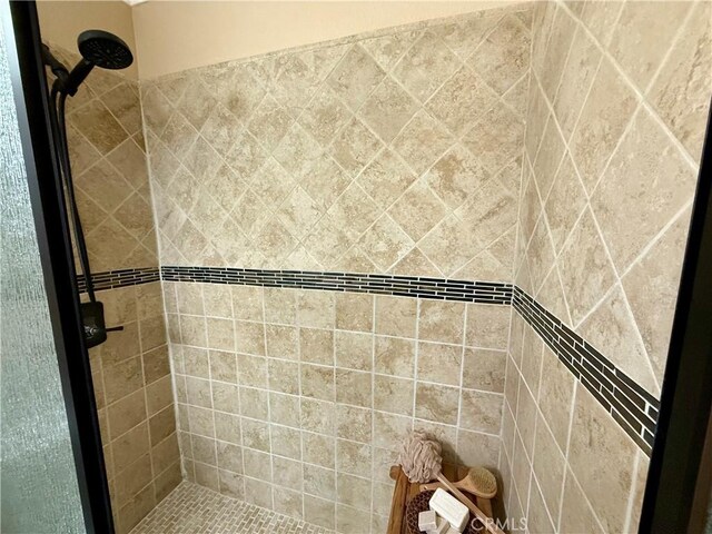 bathroom with a tile shower