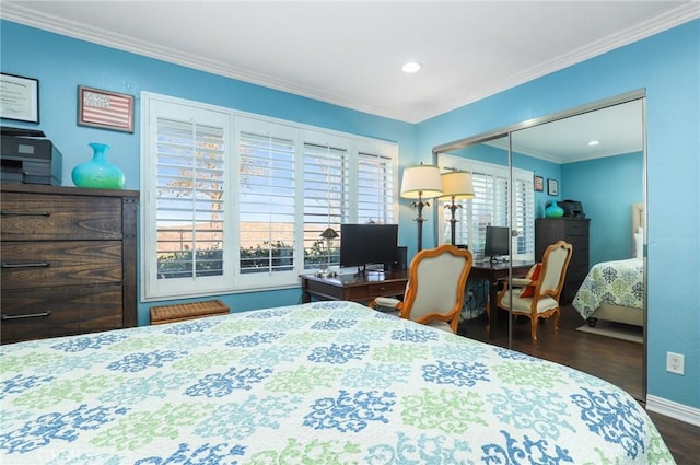 bedroom featuring dark hardwood / wood-style flooring, a closet, and crown molding