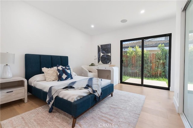 bedroom featuring light hardwood / wood-style floors and access to outside