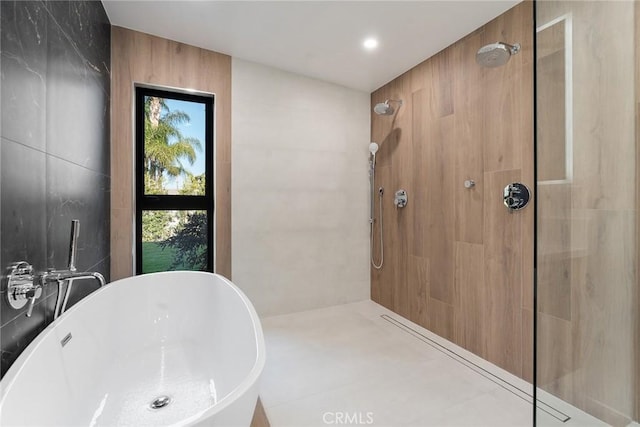 bathroom featuring sink, tile walls, and independent shower and bath