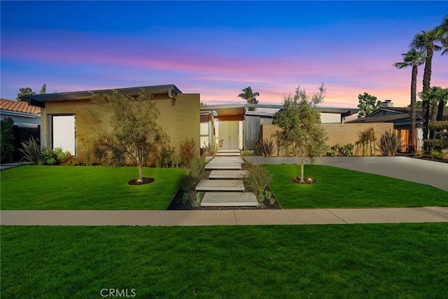 view of front of home with a yard