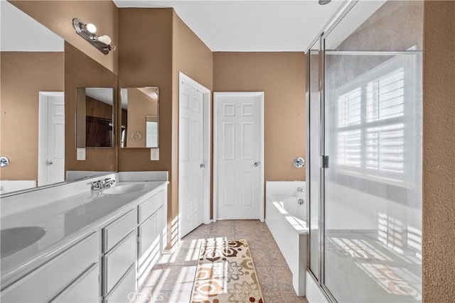 bathroom with tile patterned floors, separate shower and tub, and vanity