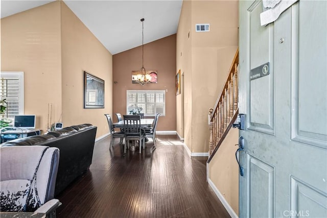 dining space featuring a chandelier, dark hardwood / wood-style floors, and high vaulted ceiling