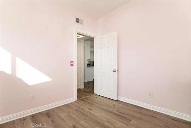 unfurnished room with light wood-type flooring