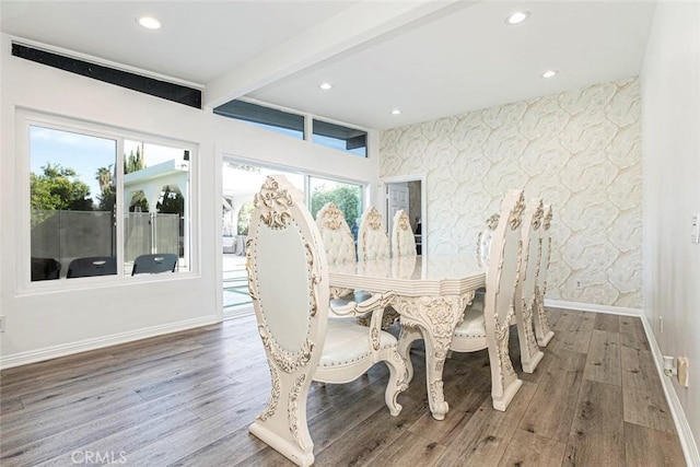 dining space with hardwood / wood-style floors and beamed ceiling