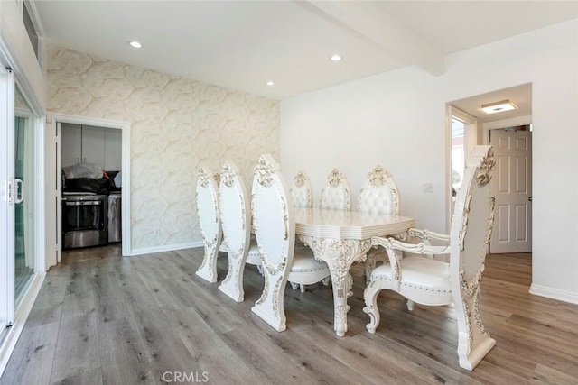 dining space with beam ceiling and light hardwood / wood-style floors