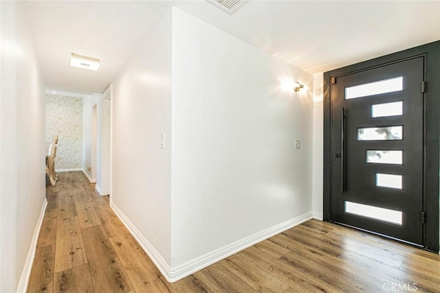 entrance foyer with a healthy amount of sunlight and light hardwood / wood-style flooring