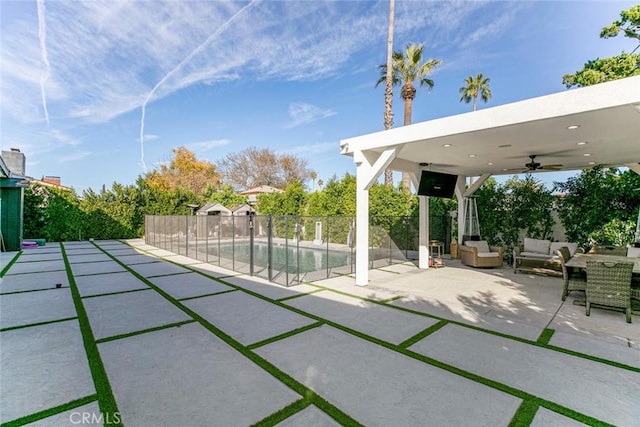 view of patio featuring an outdoor living space, a fenced in pool, and ceiling fan