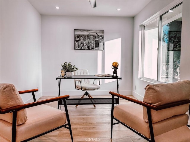 living area with light hardwood / wood-style flooring