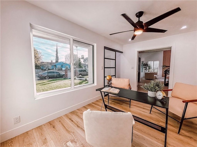 office space featuring ceiling fan and light hardwood / wood-style flooring