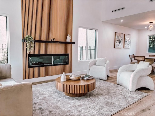 living room featuring wood-type flooring and a notable chandelier