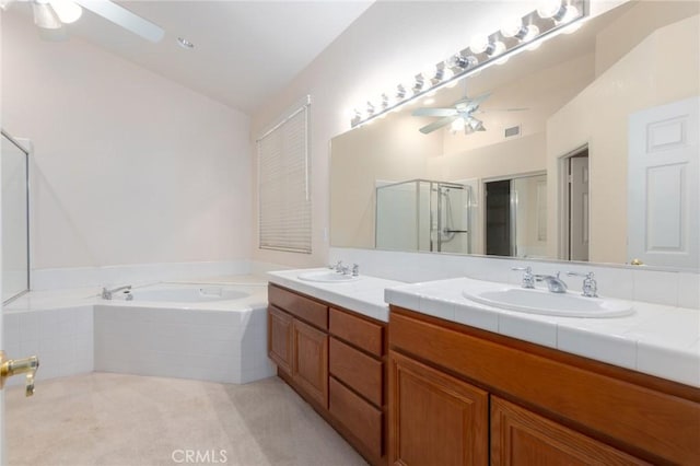 bathroom featuring ceiling fan, vanity, separate shower and tub, and vaulted ceiling