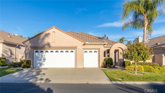 mediterranean / spanish-style house with a garage