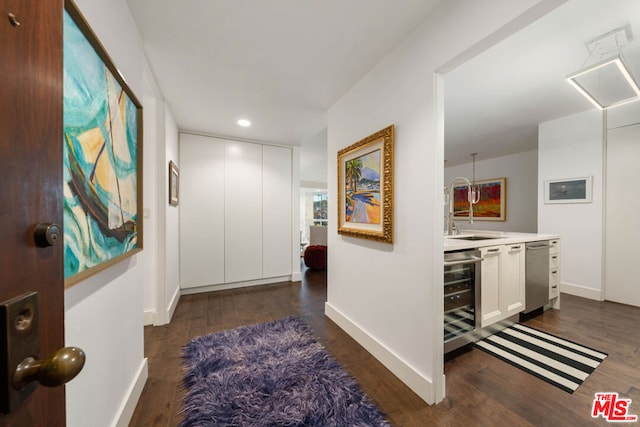 hall with sink, dark hardwood / wood-style floors, and wine cooler