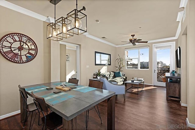 dining room with ceiling fan with notable chandelier, dark hardwood / wood-style flooring, and crown molding