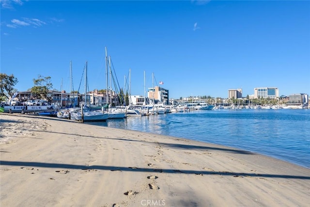 exterior space featuring a water view and a beach view