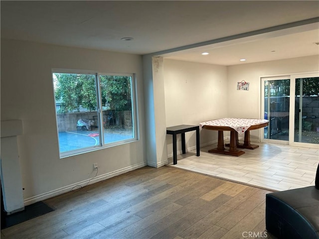 recreation room with light wood-type flooring, baseboards, and recessed lighting