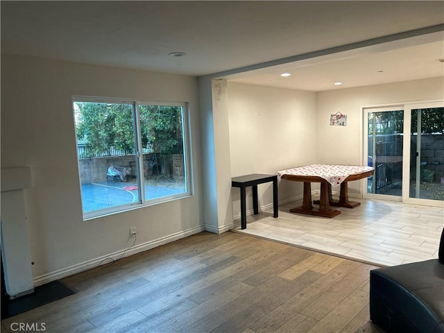 recreation room with recessed lighting, baseboards, and light wood finished floors