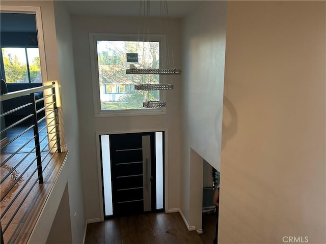 entryway with dark wood-type flooring and baseboards