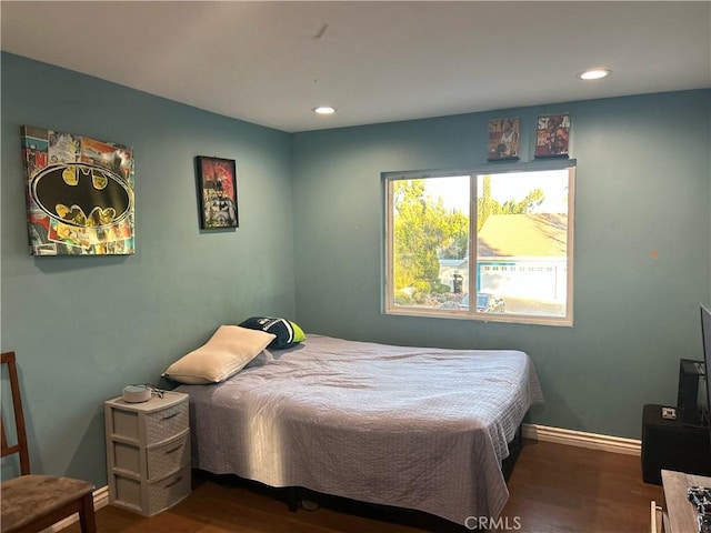 bedroom with recessed lighting, wood finished floors, and baseboards