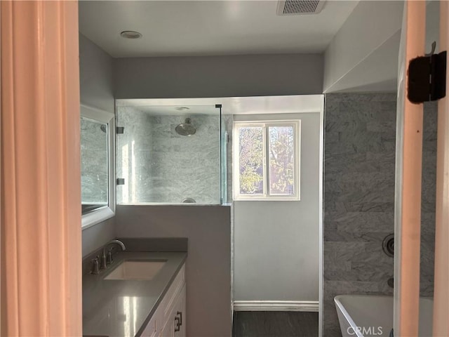 bathroom with shower / washtub combination, visible vents, vanity, and baseboards