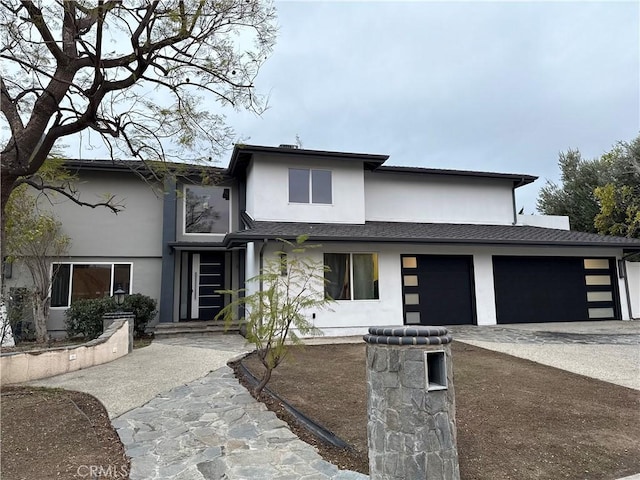 view of front of house with a garage, driveway, roof with shingles, and stucco siding