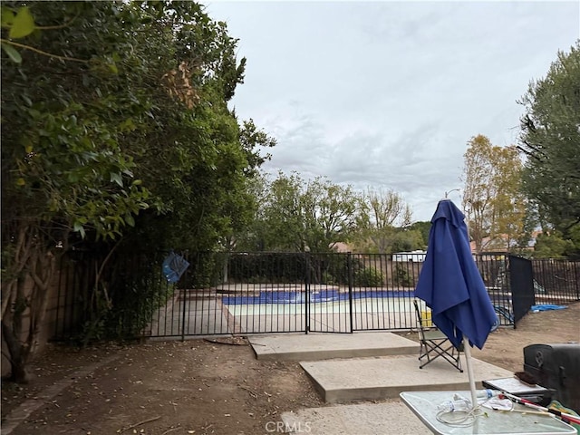 view of swimming pool with a patio, fence, and a fenced in pool