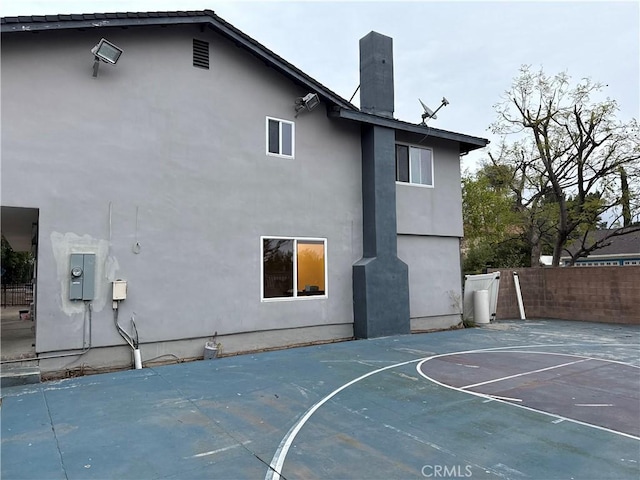 view of sport court featuring basketball court and fence