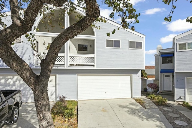 view of property with a garage and a balcony