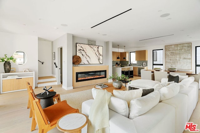 living room with beverage cooler and light wood-type flooring