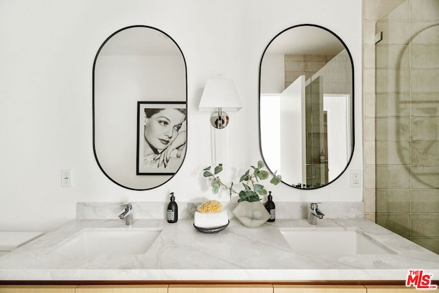 bathroom with vanity and a tile shower