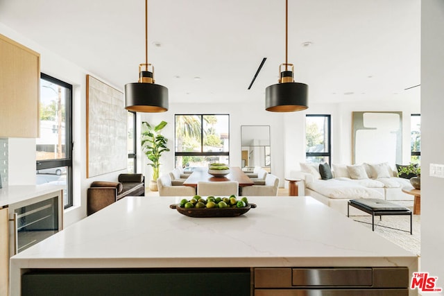 kitchen with beverage cooler and pendant lighting