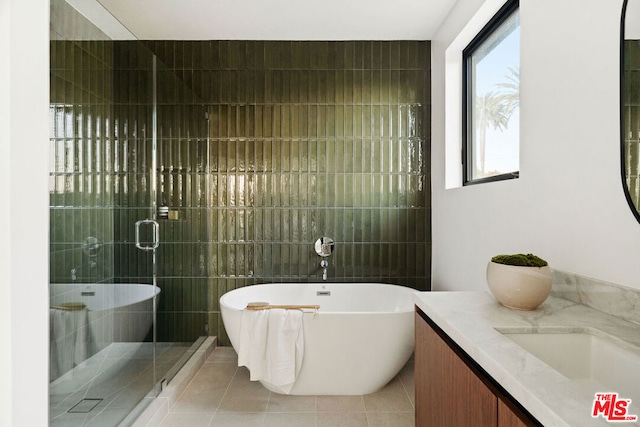 bathroom with vanity, tile patterned flooring, and shower with separate bathtub